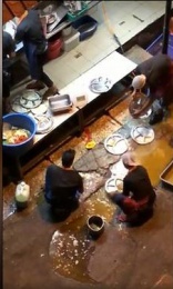 Restaurant staff filmed cleaning plates in a dirty puddle